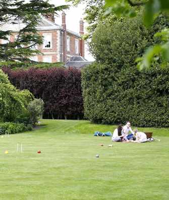 Family relaxing on croquet lawn at Middlethorpe Hall