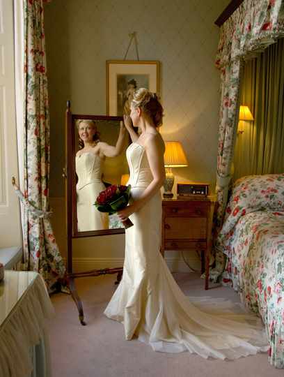 Bride in front of mirror at Middlethorpe Hall