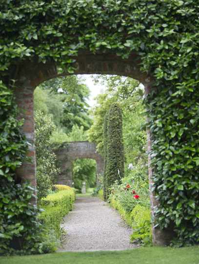 View through arched gateway to walled garden at Middlethorpe Hall