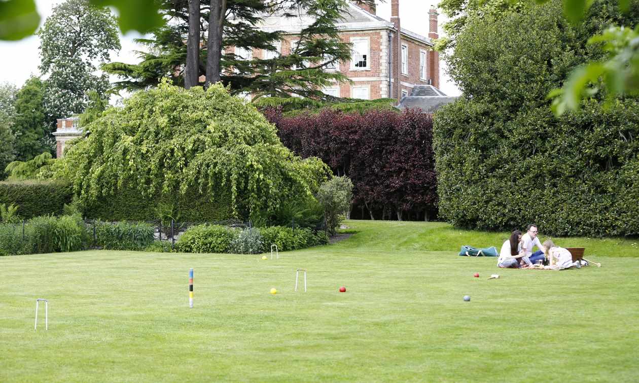 Family relaxing on croquet lawn at Middlethorpe Hall