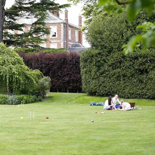 Family relaxing on croquet lawn at Middlethorpe Hall
