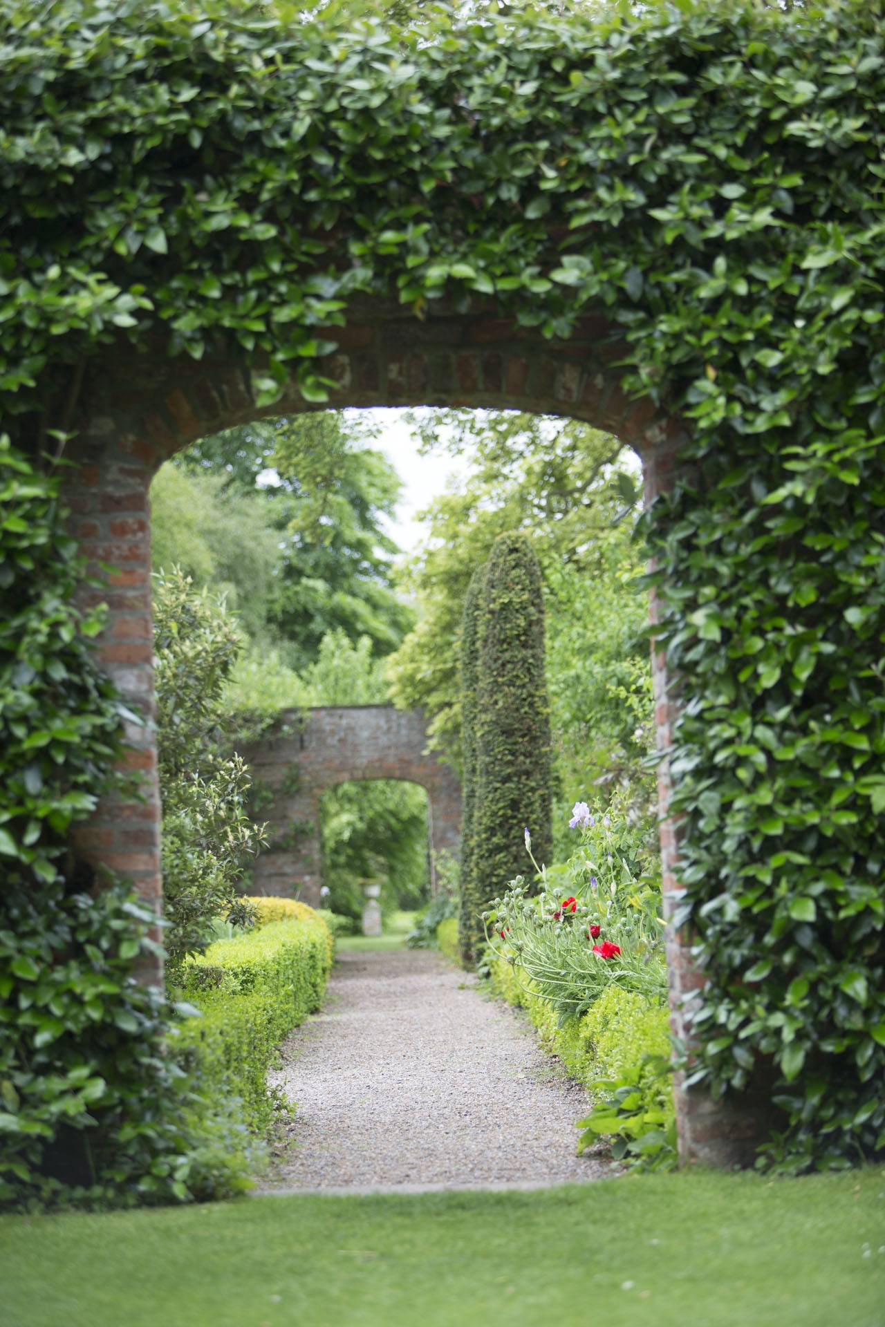 View through arched gateway to walled garden at Middlethorpe Hall