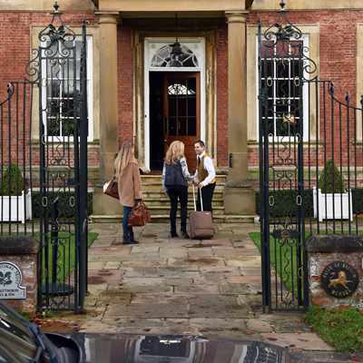 Porter greeting arrivals at entrance to Middlethorpe Hall Porter greeting arrivals at entrance to Middlethorpe Hall