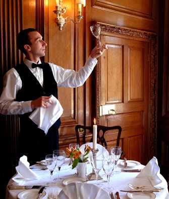 Waiter setting table in Oak Dining Room at Middlethorpe Hall Waiter setting table in Oak Dining Room at Middlethorpe Hall