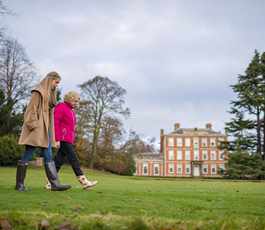 Guests taking an autumn stroll on the lawns at Middlethorpe Hall